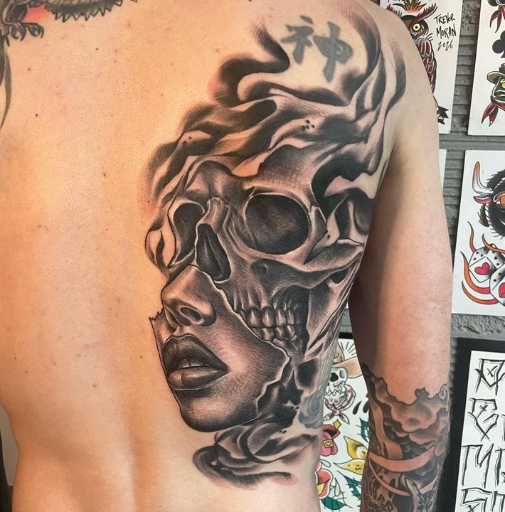 Black and grey skull and portrait back piece — tattoo at Stingray Tattoo, Regina